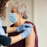 General,Practitioner,Vaccinating,Old,Patient,In,Clinic,With,Copy,Space.